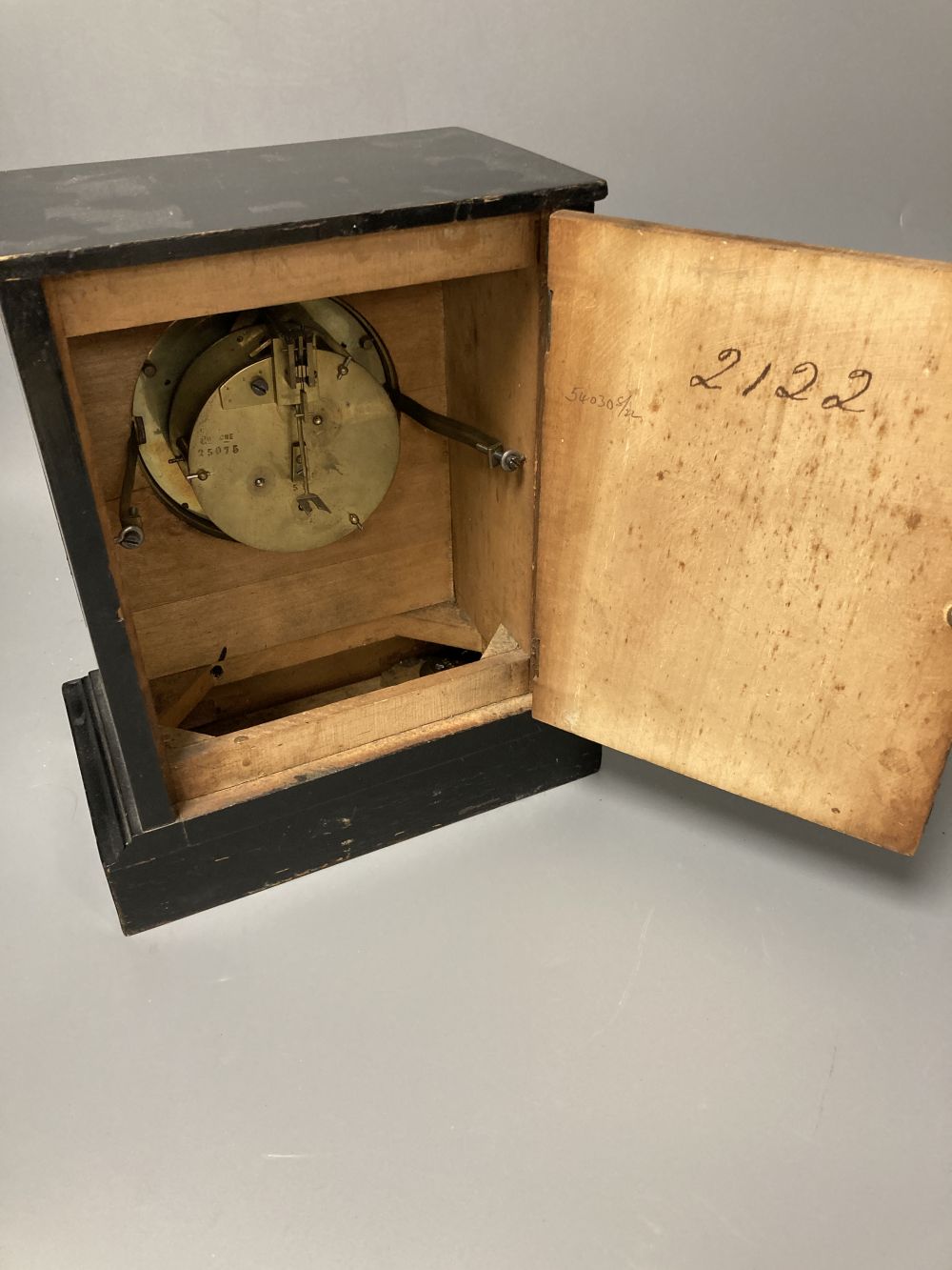 A French ebony and walnut mantel clock, height 25cm, 21cm at the base